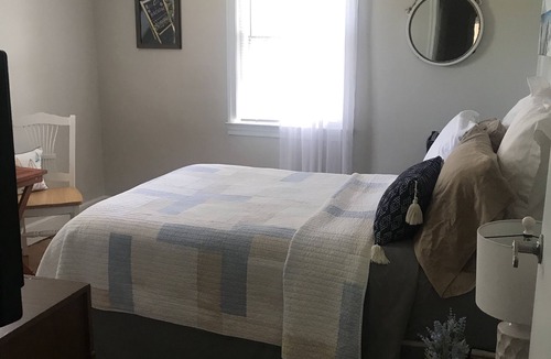 Springdale House | Charming bedroom for busy travelers needing a functional place to stay