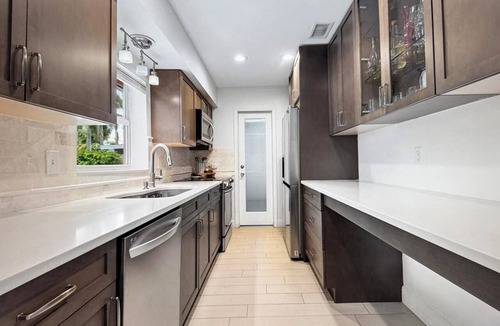 Tropic Palms House | Coastal retreat with heated saltwater pool & spa in prime Delray Beach.