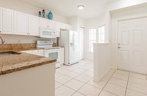 Ole Condo | Coral Falls - 1st floor condo - private screened lanai w/views of indoor 65" TV & steps to pool/spa