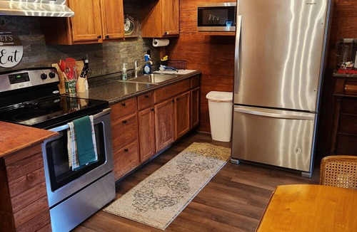 Ellabell Cabin | Cozy fishing cabin with stocked pond, near Savannah. Fenced- pet friendly!