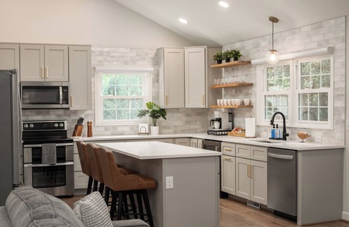Northwest Raleigh House | Experience an elevated group getaway in this renovated 3,100 sqft, 5-bdrm 3 bth. Perfect for families, it features a massive 900 sqft game room with a pool ping pong table, wet bar, & much more. Enjoy a luxurious stay with hotel-style amenities.