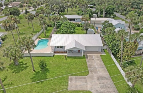 Micco House | Indian River Waterfront Home with private dock, heated pool, fenced back yard