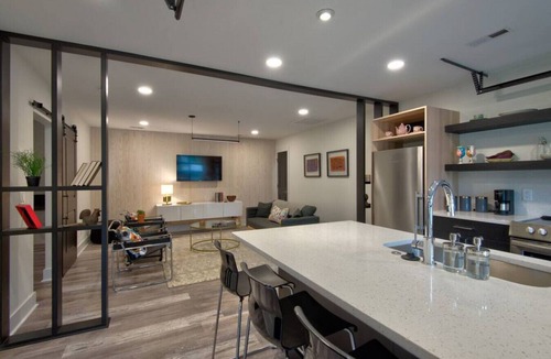 Charlotte House | Luxurious Guest House Retreat in Lower South End w/retractable glass garage door