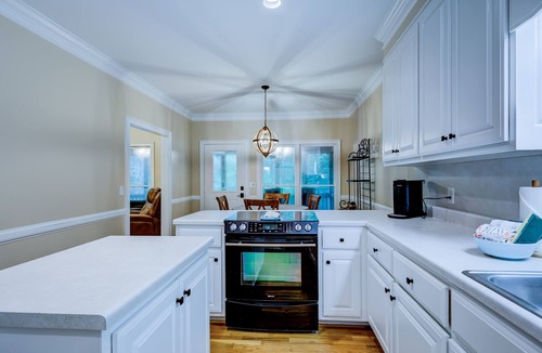 Wiley House | Riverfront hideaway with grill, game room, home theater, screened porch, & deck
