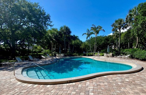 Indian River Shores Condo | Spacious condo with views of oak canopy, gardens & pool. 5-minute walk to beach.