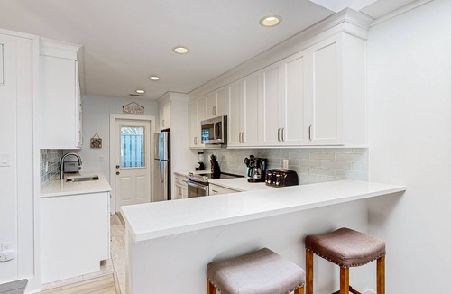Sea Pines Condo | Updated, waterfront condo with amazing lagoon & golf views from the sunroom