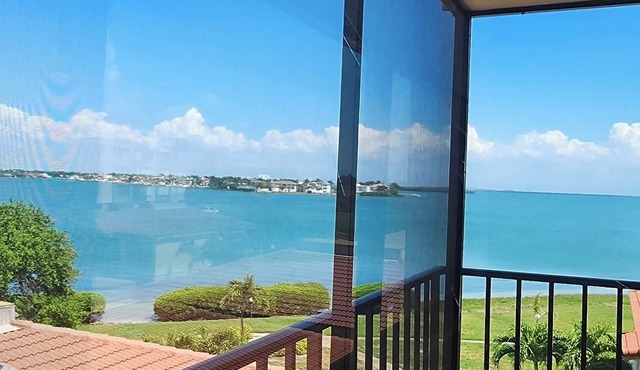 Enjoy spectacular sunrises and water views from this 4th floor condo in Isla!