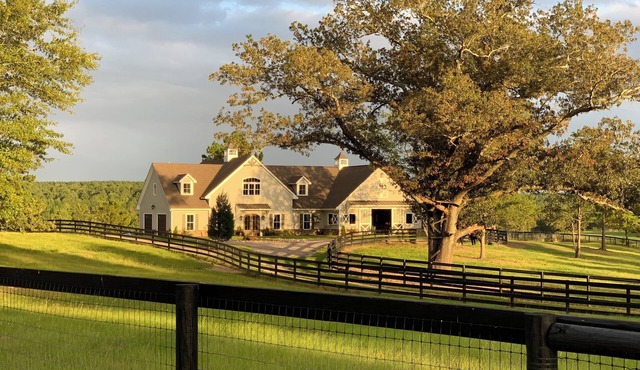 Stunning farmhouse in private, gated equestrian community.